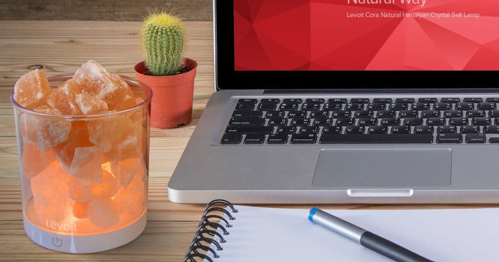 A salt lamp by a laptop - Increase your energy levels, even at work!