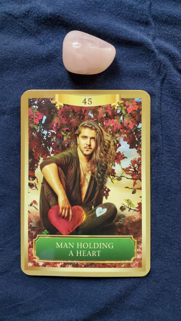 The second card in this Angel Reading for love, wealth and health is "Man Holding a Heart."